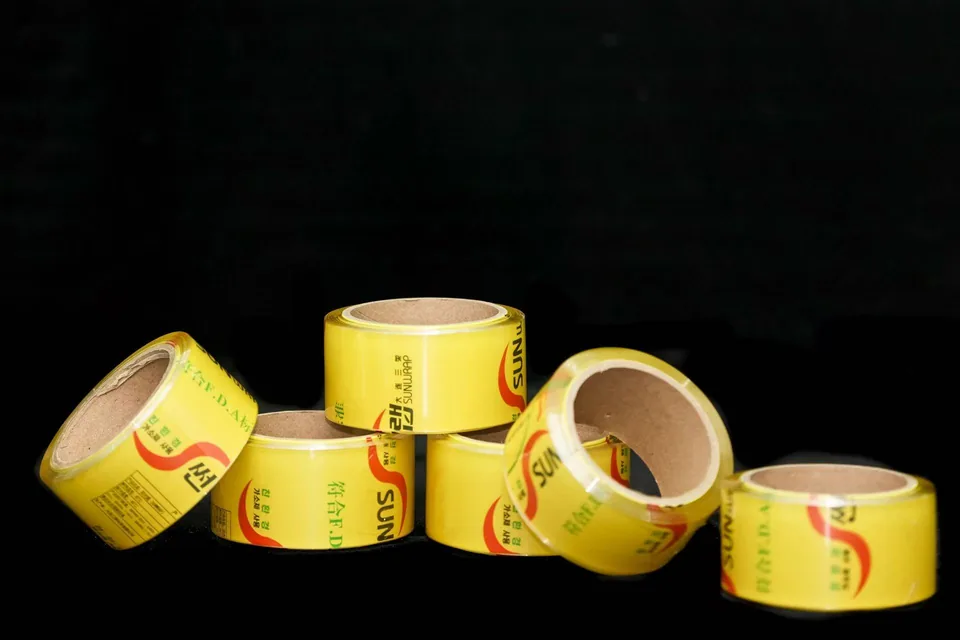 Rolls of SUNWRAP food-grade PVC cling film with FDA-compliant yellow packaging